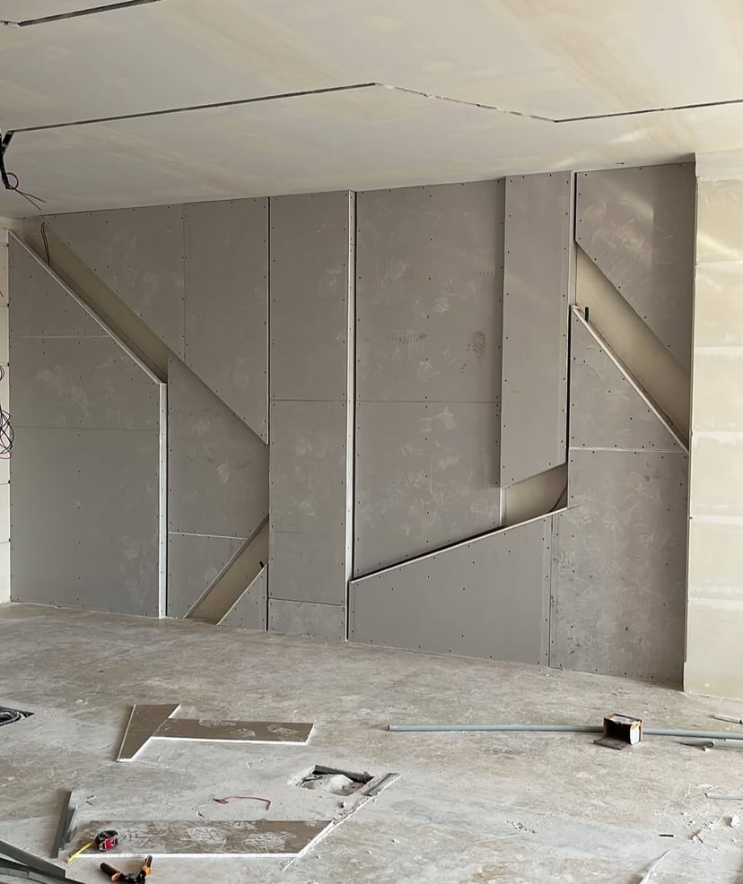 Exterior Wall Gypsum Board Application Gypsum board installation on exterior wall with proper moisture barriers and insulation